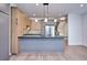 Contemporary kitchen featuring stainless steel appliances and an island with a sink and stone countertop at 1821 N Grove St, Denver, CO 80204