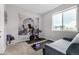 Bright room featuring a Peloton bike, carpet, and a large tapestry at 5371 E 63Rd Pl, Commerce City, CO 80022