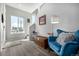 Inviting foyer with hardwood floors, a stylish blue chair, and bright natural light from a nearby window at 5371 E 63Rd Pl, Commerce City, CO 80022