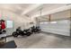 Spacious garage featuring two motorcycles, ample storage space, and a convenient automatic garage door opener at 5371 E 63Rd Pl, Commerce City, CO 80022