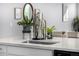 Bright kitchen with a large sink, white countertops, stylish fixtures, and modern appliances, perfect for cooking at 5371 E 63Rd Pl, Commerce City, CO 80022