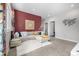 Inviting living room features a sectional sofa, area rug, and colorful accent wall with decorative artwork at 5371 E 63Rd Pl, Commerce City, CO 80022