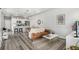 Open living space with a cozy seating area, dining table, and modern kitchen island, great for entertaining at 5371 E 63Rd Pl, Commerce City, CO 80022