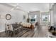 Bright living room featuring dining area, modern lighting, and stylish decor with hardwood floors at 5371 E 63Rd Pl, Commerce City, CO 80022