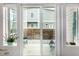 Relaxing patio area with sliding glass doors, modern furniture, and views of the landscaped yard at 5371 E 63Rd Pl, Commerce City, CO 80022