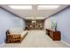 Finished basement area featuring built-in shelving, carpet flooring and recessed lighting at 6323 W Rowland Cir, Littleton, CO 80128