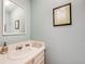 Charming half bathroom with a white sink and vanity, complemented by blue walls at 6323 W Rowland Cir, Littleton, CO 80128