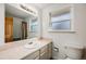 Bright bathroom with a neutral vanity, tile countertop, and shower with a curtain at 6323 W Rowland Cir, Littleton, CO 80128