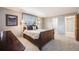 Comfortable bedroom featuring neutral tones, a queen bed, and an ensuite bathroom at 6323 W Rowland Cir, Littleton, CO 80128