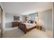 Cozy bedroom with a sleigh bed, soft carpet, and natural light from the window at 6323 W Rowland Cir, Littleton, CO 80128