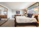 Bright bedroom with natural light, a sleigh bed, and a mirrored closet at 6323 W Rowland Cir, Littleton, CO 80128