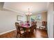 Elegant dining room with hardwood floors, chandelier, and seating for eight at 6323 W Rowland Cir, Littleton, CO 80128