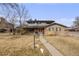 Charming two-story brick home with manicured lawn and inviting walkway at 6323 W Rowland Cir, Littleton, CO 80128