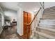 Inviting foyer with hardwood floors, staircase, closet, and a glimpse of the living room at 6323 W Rowland Cir, Littleton, CO 80128