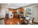 Charming kitchen featuring wooden cabinets, granite countertops, and a bright breakfast nook at 6323 W Rowland Cir, Littleton, CO 80128