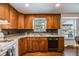 Traditional kitchen with wooden cabinets, granite countertops, and stainless steel appliances at 6323 W Rowland Cir, Littleton, CO 80128