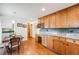 Spacious kitchen featuring wooden cabinets, granite countertops, and a cozy breakfast area at 6323 W Rowland Cir, Littleton, CO 80128