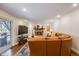 Inviting living room featuring leather seating, a fireplace, and sliding doors to the patio at 6323 W Rowland Cir, Littleton, CO 80128