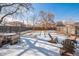 Spacious backyard with a dining table, seating area, and snow-covered lawn at 2455 Lowell Blvd, Denver, CO 80211