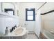 Stylish bathroom features white subway tiles, black accents, and classic fixtures at 2455 Lowell Blvd, Denver, CO 80211