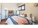 Comfortable bedroom with hardwood floors, a large mirror, and plenty of natural light at 2455 Lowell Blvd, Denver, CO 80211