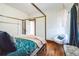 Cozy bedroom featuring hardwood floors, a four-poster bed, and a stylish chandelier at 2455 Lowell Blvd, Denver, CO 80211