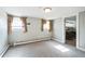 Neutral bedroom with carpet, two windows, and access to the hall at 2455 Lowell Blvd, Denver, CO 80211