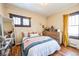 Cozy bedroom featuring hardwood floors, bright windows, and comfortable furnishings at 2455 Lowell Blvd, Denver, CO 80211