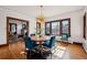 Inviting dining space with hardwood floors, modern chandelier, and access to the living room at 2455 Lowell Blvd, Denver, CO 80211