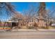 Brick home featuring traditional architecture, complemented by mature trees and a side yard at 2455 Lowell Blvd, Denver, CO 80211