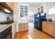 Bright kitchen with white brick accent, granite counters, and stainless steel appliances at 2455 Lowell Blvd, Denver, CO 80211