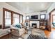 Inviting living room with hardwood floors, fireplace, stylish decor, and lots of natural light at 2455 Lowell Blvd, Denver, CO 80211