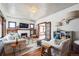 Cozy living room with hardwood floors, fireplace, modern furniture, and ample natural light at 2455 Lowell Blvd, Denver, CO 80211