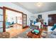 Bright living room featuring hardwood floors, stylish seating, and seamless flow to dining area at 2455 Lowell Blvd, Denver, CO 80211