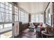 Cozy sun room with lots of natural light, brick accents, and comfortable seating at 2455 Lowell Blvd, Denver, CO 80211