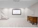 Finished basement with movie projector and screen, storage and carpet at 1653 S Logan St, Denver, CO 80210