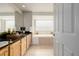 Bright bathroom with double sinks, granite countertops, and a soaking tub at 1653 S Logan St, Denver, CO 80210