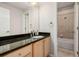 Stylish bathroom featuring a granite countertop vanity and tiled shower and bathtub at 1653 S Logan St, Denver, CO 80210