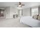 Spacious bedroom featuring a ceiling fan, ensuite access, and comfortable carpeting at 1653 S Logan St, Denver, CO 80210