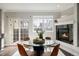 Inviting dining area with fireplace and view of backyard at 1653 S Logan St, Denver, CO 80210