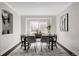 Stylish dining room with a large table, modern chairs, and a view of the front yard at 1653 S Logan St, Denver, CO 80210