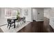Open dining room with hardwood floors, modern chairs and a view of the yard at 1653 S Logan St, Denver, CO 80210