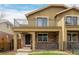 Charming two-story home with brick accents, a balcony, and a cozy front porch at 1653 S Logan St, Denver, CO 80210