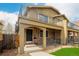 Attractive two-story home featuring a balcony, brick accents, and covered front porch at 1653 S Logan St, Denver, CO 80210