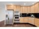 This kitchen has stainless steel appliances and wooden cabinets at 1653 S Logan St, Denver, CO 80210