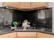 Cooktop with black countertops and wooden cabinets at 1653 S Logan St, Denver, CO 80210
