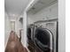Efficient laundry area with modern washer and dryer units and ample storage at 1653 S Logan St, Denver, CO 80210