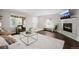 Cozy living room with a fireplace, hardwood floors, natural light, and modern décor at 1653 S Logan St, Denver, CO 80210