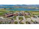 Stunning aerial view of the clubhouse, golf course and lake, highlighting its beautiful setting at 200 Bothun Rd, Berthoud, CO 80513