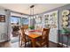 Cozy dining room with wood table and chairs, a white cabinet, and sliding glass doors to the deck at 200 Bothun Rd, Berthoud, CO 80513